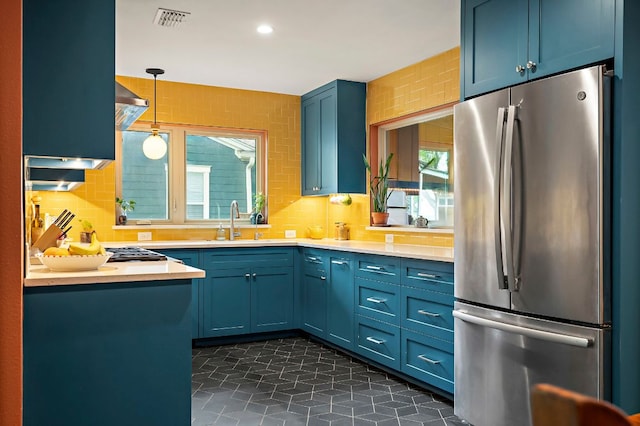 1516 Madison Ave, Austin, TX 78757 - kitchen with freestanding refrigerator, light countertops, blue cabinets, and recessed lighting