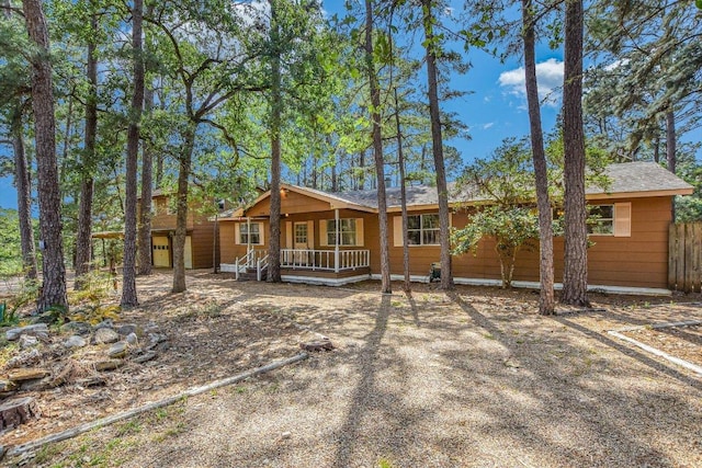 view of front facade featuring fence and a porch