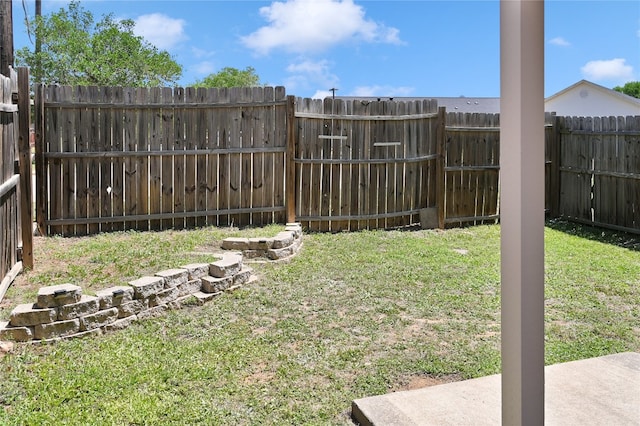 view of yard with a fenced backyard