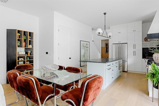 dining space with light wood finished floors