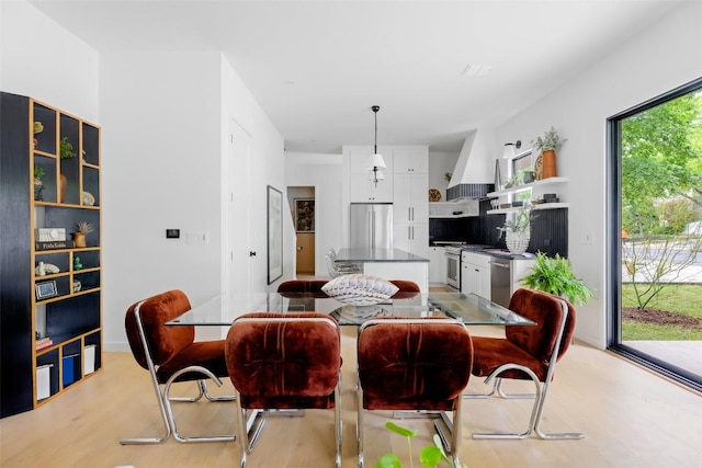 dining space with light wood-style floors