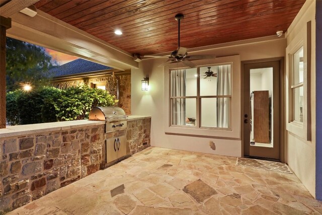 view of patio featuring ceiling fan, exterior kitchen, and grilling area