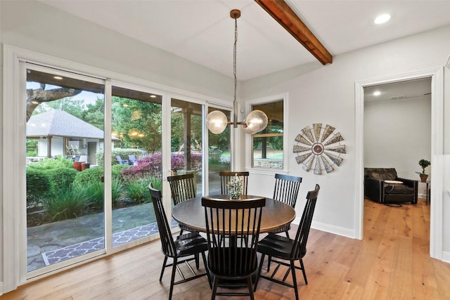 dining area featuring a notable chandelier, beam ceiling, light wood-style flooring, recessed lighting, and baseboards