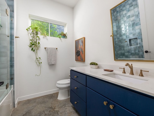 11000 5th St, Leander, TX 78645 - full bath with vanity, toilet, baseboards, concrete floors, and shower / bath combination with glass door