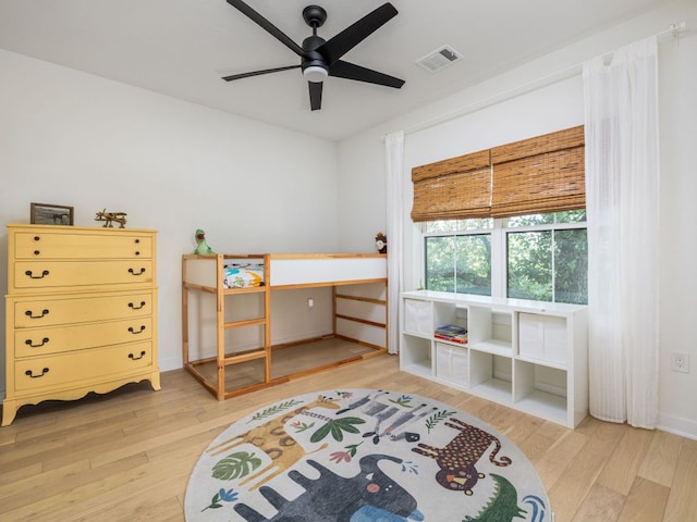 bedroom with ceiling fan, visible vents, baseboards, and light wood-type flooring