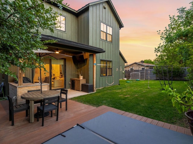 11000 5th St, Leander, TX 78645 - back of house featuring a wooden deck, outdoor dining area, board and batten siding, and cooling unit