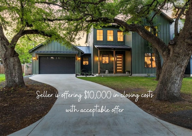 view of front of home featuring a standing seam roof, board and batten siding, driveway, and a garage