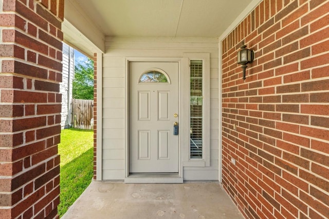 doorway to property featuring fence