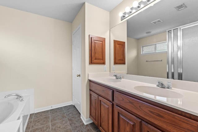 bathroom featuring double vanity, visible vents, and a sink
