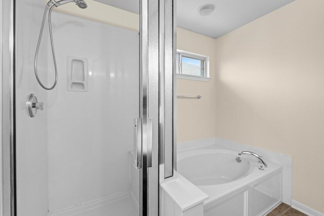 bathroom featuring a garden tub and a stall shower