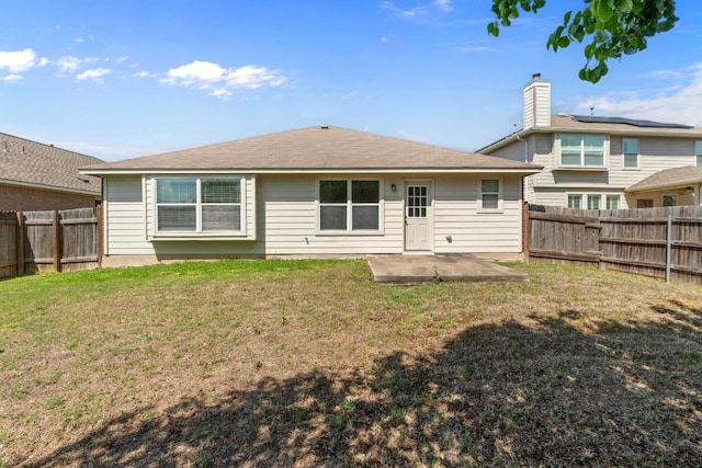 back of house featuring a yard, a fenced backyard, and a patio area