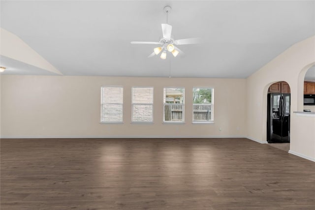 empty room with ceiling fan, wood finished floors, and lofted ceiling