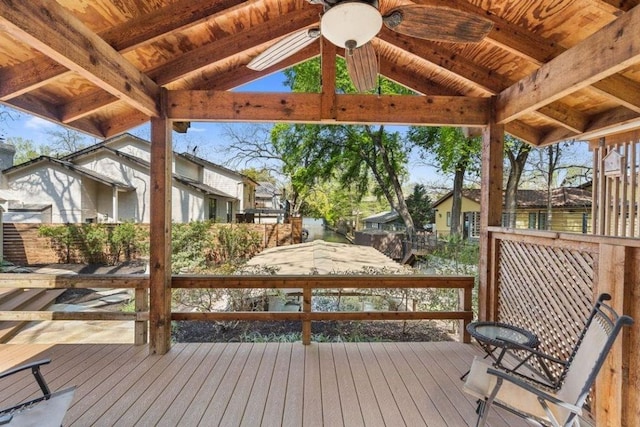 deck featuring ceiling fan and a residential view