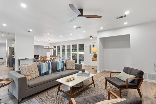 living area featuring visible vents, baseboards, ceiling fan, recessed lighting, and light wood-type flooring