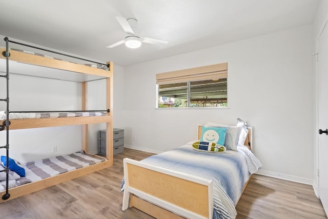 bedroom with baseboards, a ceiling fan, and wood finished floors
