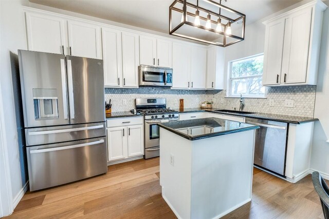 1161 Stone Forest Trl, Round Rock, TX 78681 - kitchen with appliances with stainless steel finishes, a sink, light wood-style flooring, backsplash, and white cabinets