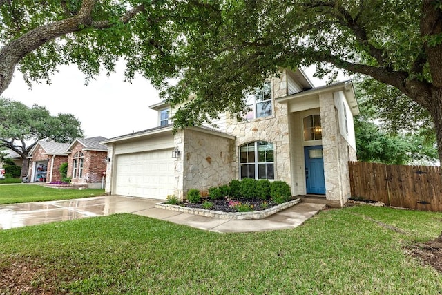 view of front of property featuring fence, a front lawn, stone siding, a garage, and driveway