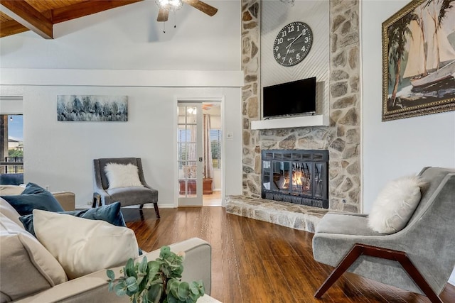living room with a fireplace, a ceiling fan, wood finished floors, and a wealth of natural light