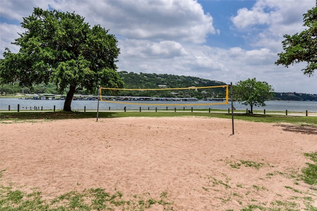view of community featuring volleyball court and a water view