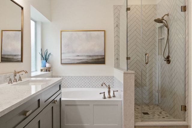 bathroom with a shower stall, a garden tub, and vanity