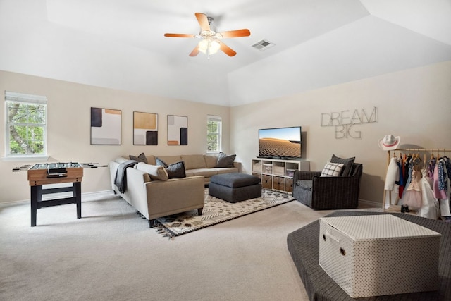 carpeted living area featuring visible vents, plenty of natural light, lofted ceiling, and ceiling fan