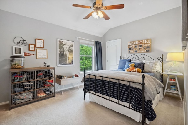 carpeted bedroom featuring baseboards, ceiling fan, and vaulted ceiling