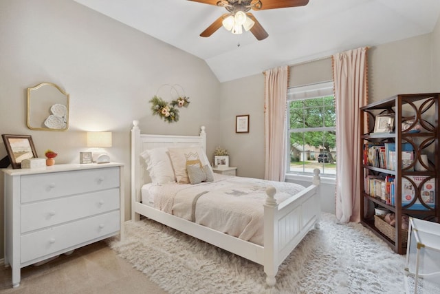 bedroom featuring a ceiling fan, lofted ceiling, and light colored carpet
