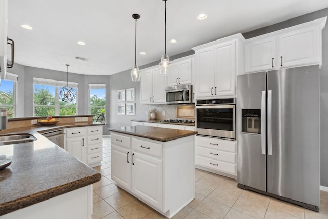 kitchen featuring a kitchen island, recessed lighting, appliances with stainless steel finishes, and visible vents