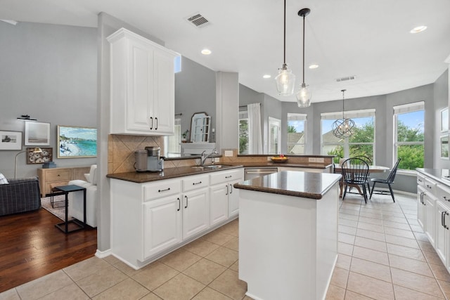kitchen with recessed lighting, dark countertops, and visible vents