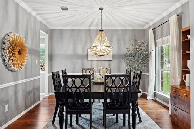 dining room with baseboards, visible vents, wood finished floors, and an inviting chandelier