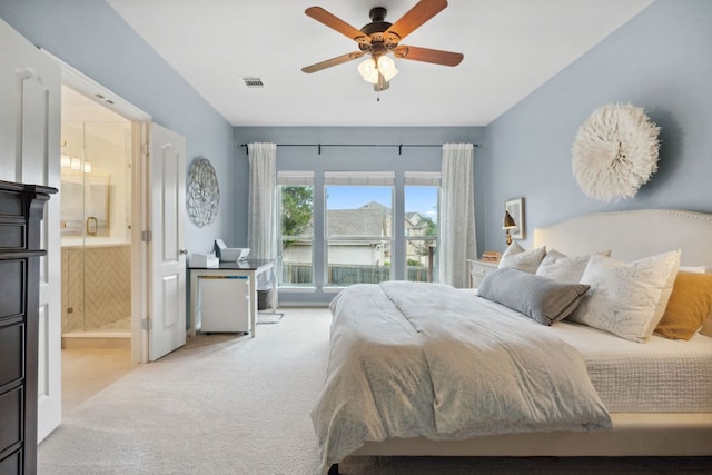 carpeted bedroom featuring connected bathroom, ceiling fan, and visible vents