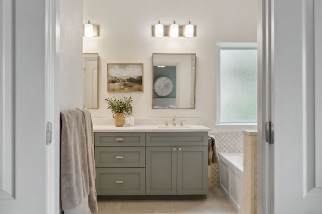 full bath featuring vanity, tile patterned flooring, and a bath