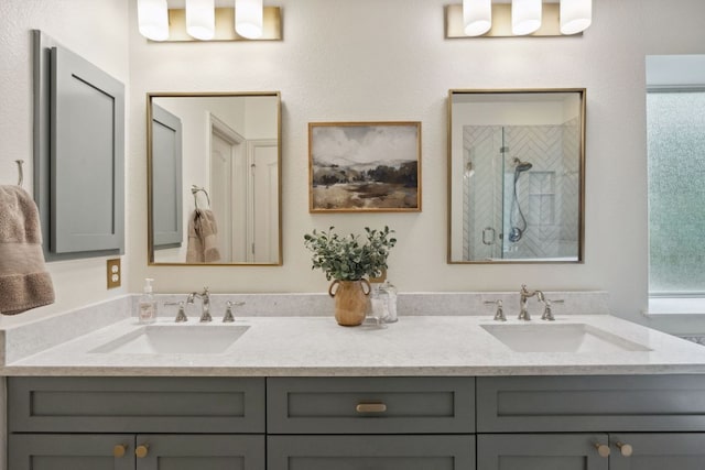 full bath with double vanity, a sink, and a stall shower