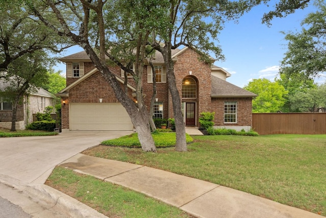 traditional-style house with driveway, roof with shingles, brick siding, fence, and a front lawn