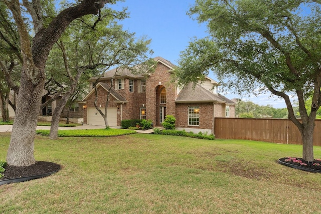 traditional-style house with brick siding, a front lawn, and fence