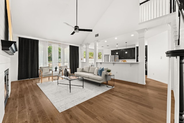 13300 Country Lake Dr, Austin, TX 78732 - living room featuring decorative columns, wood finished floors, baseboards, high vaulted ceiling, and a ceiling fan