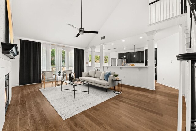 13300 Country Lake Dr, Austin, TX 78732 - living area featuring decorative columns, a ceiling fan, high vaulted ceiling, wood finished floors, and recessed lighting