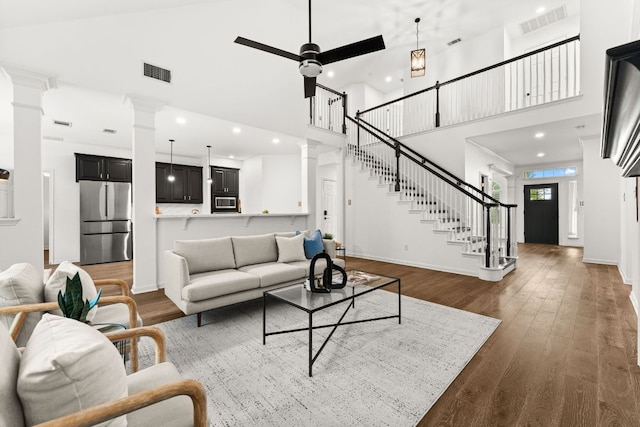 13300 Country Lake Dr, Austin, TX 78732 - living area with stairs, baseboards, decorative columns, a towering ceiling, and visible vents