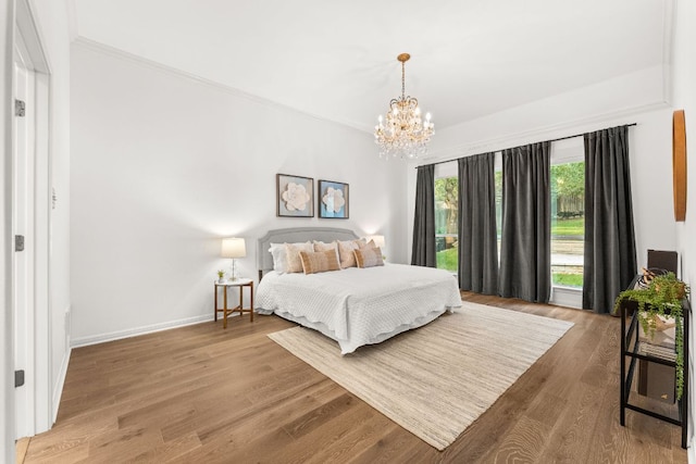 13300 Country Lake Dr, Austin, TX 78732 - bedroom featuring baseboards, ornamental molding, wood finished floors, and a notable chandelier