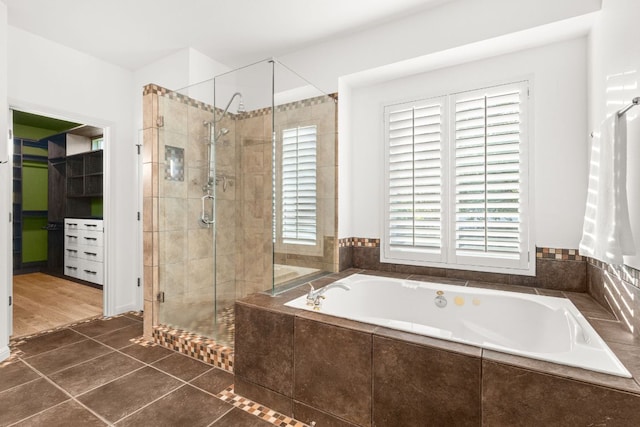 13300 Country Lake Dr, Austin, TX 78732 - full bathroom featuring tile patterned floors, a spacious closet, a garden tub, and a stall shower