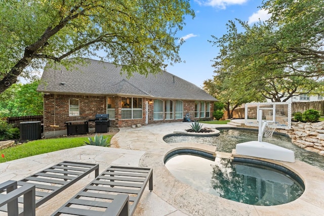 13300 Country Lake Dr, Austin, TX 78732 - rear view of house featuring an in ground hot tub, central AC unit, brick siding, a fenced backyard, and a patio