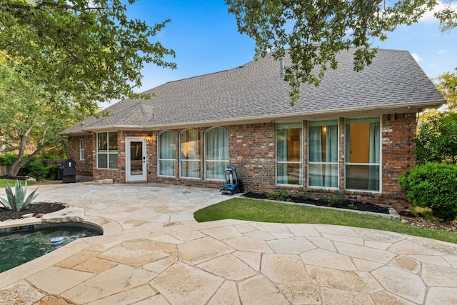 13300 Country Lake Dr, Austin, TX 78732 - back of house featuring a patio, brick siding, a shingled roof, and an in-ground hot tub
