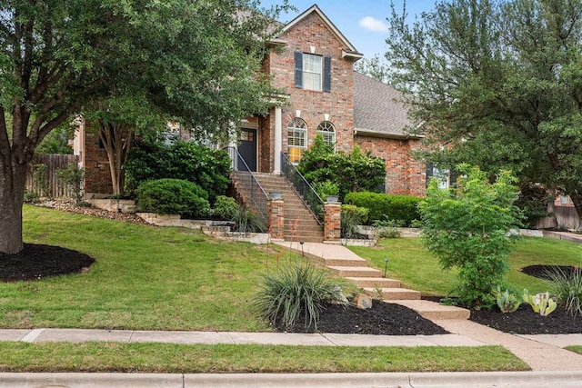 13300 Country Lake Dr, Austin, TX 78732 - traditional home featuring brick siding, a front lawn, fence, and stairway