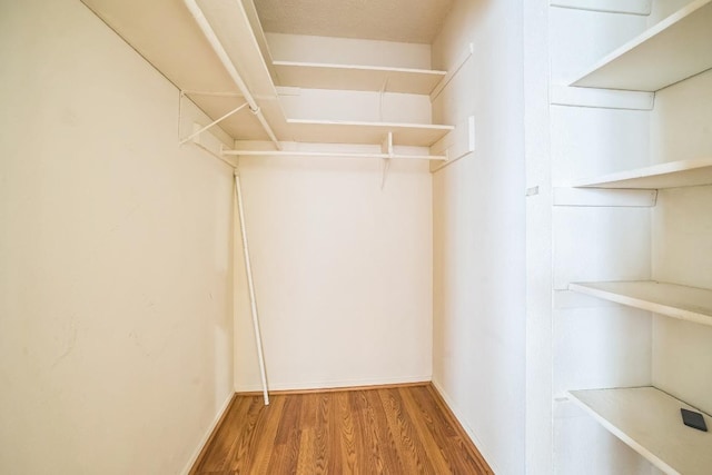 spacious closet with wood finished floors