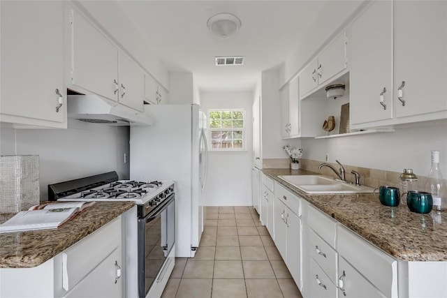 8221 Renton Dr, Austin, TX 78757 - kitchen featuring visible vents, gas range oven, under cabinet range hood, a sink, and light tile patterned floors