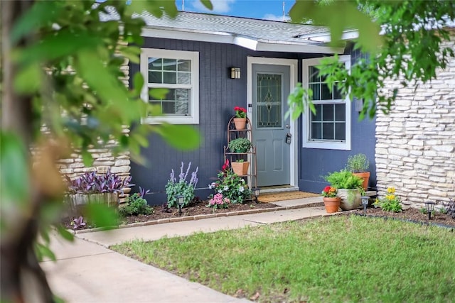 8221 Renton Dr, Austin, TX 78757 - view of exterior entry with a shingled roof
