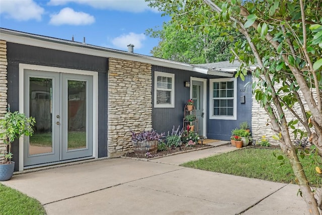 8221 Renton Dr, Austin, TX 78757 - doorway to property featuring a patio, french doors, and stone siding