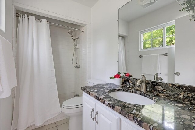 8221 Renton Dr, Austin, TX 78757 - bathroom featuring vanity, toilet, a tile shower, and tile patterned floors