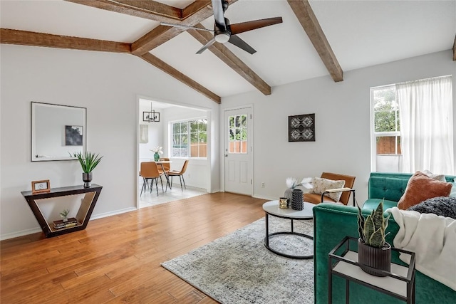 8221 Renton Dr, Austin, TX 78757 - living room with baseboards, ceiling fan, a healthy amount of sunlight, and light wood-type flooring