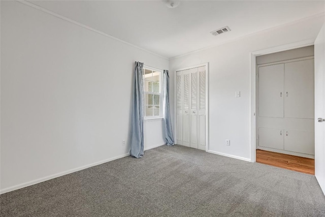 8221 Renton Dr, Austin, TX 78757 - unfurnished bedroom with visible vents, crown molding, carpet floors, a closet, and baseboards